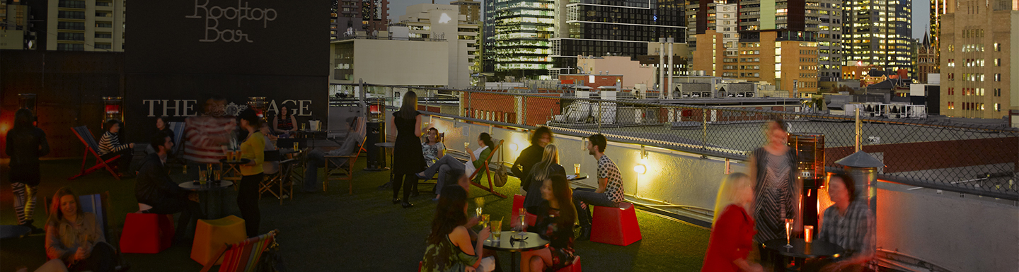 People enjoying themselves on Melbourne CBD rooftop bar at dusk